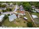 Aerial view of a property featuring a generous yard, RV, and multiple outbuildings and home in a residential neighborhood at 217 Regal Park Dr, Valrico, FL 33594