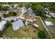 Aerial view of a property featuring a spacious yard, RV, and multiple outbuildings and home in a residential neighborhood at 217 Regal Park Dr, Valrico, FL 33594