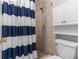 Bathroom shower with tile surround, a shower head, and built-in shelving at 217 Regal Park Dr, Valrico, FL 33594
