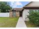 Welcoming front entrance with a brown door, stone accents, and a landscaped walkway at 217 Regal Park Dr, Valrico, FL 33594