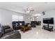 Spacious living room featuring tile flooring, modern fan, and ample seating at 217 Regal Park Dr, Valrico, FL 33594