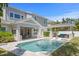 This backyard includes a luxurious pool with a lounge area, outdoor kitchen, and covered seating at 2316 S Thixton Ct, Tampa, FL 33629