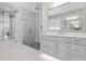 Elegant bathroom featuring a glass shower, vanity with marble countertop, and mirror wall at 2316 S Thixton Ct, Tampa, FL 33629