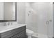 Modern bathroom featuring glass enclosed shower, gray vanity, and tiled floors at 2316 S Thixton Ct, Tampa, FL 33629