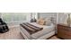 Bright bedroom featuring wood floors, large windows, and neutral decor at 2316 S Thixton Ct, Tampa, FL 33629