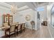 Dining room featuring a modern chandelier, a glass cabinet, and seating for eight at 2316 S Thixton Ct, Tampa, FL 33629