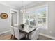Bright dining room with modern lighting fixture and large window for natural light at 2316 S Thixton Ct, Tampa, FL 33629