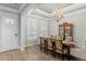Formal dining room with an elegant chandelier, wainscoting, and a glass cabinet at 2316 S Thixton Ct, Tampa, FL 33629