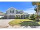 Charming two-story home with manicured lawn, three-car garage and beautifully designed façade at 2316 S Thixton Ct, Tampa, FL 33629