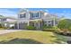 Charming two-story home with a well-manicured lawn and a two-car garage; features gray siding and black shutters at 2316 S Thixton Ct, Tampa, FL 33629