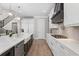 Modern kitchen featuring white cabinets, stainless appliances, large island and wood floors at 2316 S Thixton Ct, Tampa, FL 33629