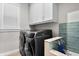 Convenient laundry room featuring modern washer and dryer units with stylish backsplash at 2316 S Thixton Ct, Tampa, FL 33629