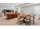 This expansive living room has a leather sofa, a wood table, a TV, and large windows for lots of natural light at 2316 S Thixton Ct, Tampa, FL 33629