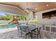 Enjoy outdoor living with a kitchen, bar, grill, dining area, television, and pool nearby at 2316 S Thixton Ct, Tampa, FL 33629