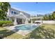 Backyard boasts a stunning pool, outdoor kitchen and covered seating area at 2316 S Thixton Ct, Tampa, FL 33629