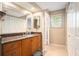 Bathroom with granite countertop, vanity, large mirror, and plenty of storage in the bright space at 2599 Dolly Bay Dr # 209, Palm Harbor, FL 34684