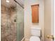 Modern bathroom features a glass-enclosed shower with decorative tile accents and a toilet and vanity at 2599 Dolly Bay Dr # 209, Palm Harbor, FL 34684