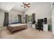 Bright bedroom with ceiling fan, neutral walls, and a white desk, offering a comfortable living space at 2599 Dolly Bay Dr # 209, Palm Harbor, FL 34684
