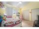 Sunlit bedroom with a ceiling fan and a floral bedspread and a desk space at 2599 Dolly Bay Dr # 209, Palm Harbor, FL 34684