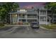 Exterior view of complex with well-kept landscaping and parking area in front at 2599 Dolly Bay Dr # 209, Palm Harbor, FL 34684