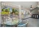Relaxing porch with wicker furniture and screened windows offering views of the street at 2599 Dolly Bay Dr # 209, Palm Harbor, FL 34684