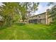Spacious backyard with a pool, green lawn, mature trees, and screened in porch at 2812 Ormandy Ct, Tampa, FL 33618