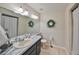 Inviting bathroom with a marble countertop, updated mirror, and decorative wreaths for a cozy touch at 2812 Ormandy Ct, Tampa, FL 33618