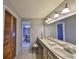 Bathroom featuring a long vanity with double mirrors and a peek to the toilet area at 2812 Ormandy Ct, Tampa, FL 33618