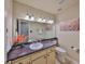 Well-lit bathroom featuring a large mirror, decorative lights, stylish sink, and fresh paint, providing a clean aesthetic at 2812 Ormandy Ct, Tampa, FL 33618
