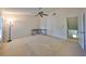 Spacious bedroom featuring neutral carpet, a ceiling fan, and an adjacent doorway at 2812 Ormandy Ct, Tampa, FL 33618