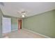 This bedroom features neutral carpet, fresh green walls, and wooden closet door for a warm feel at 2812 Ormandy Ct, Tampa, FL 33618