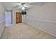 Bedroom featuring plush carpet, ceiling fan, closet, and neutral paint that will complement any decor at 2812 Ormandy Ct, Tampa, FL 33618
