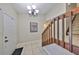 Welcoming entryway featuring tile flooring, a chandelier, staircase, and stylish decor, setting a sophisticated tone at 2812 Ormandy Ct, Tampa, FL 33618