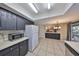 Bright kitchen with black cabinets and white appliances overlooking the living room and access to the patio at 2812 Ormandy Ct, Tampa, FL 33618