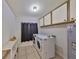 Functional laundry room equipped with modern washer and dryer, upper cabinets, and ample storage space for convenience at 2812 Ormandy Ct, Tampa, FL 33618