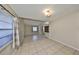 Large living room with tile flooring, natural light, and seamless transition to the dining area, perfect for entertaining at 2812 Ormandy Ct, Tampa, FL 33618