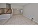 Expansive living room with tile flooring, a staircase, and neutral tones, creating a versatile and welcoming space at 2812 Ormandy Ct, Tampa, FL 33618