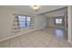 Spacious living room with tile flooring, two windows, and neutral paint, offering a bright and inviting atmosphere at 2812 Ormandy Ct, Tampa, FL 33618