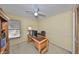 Office space with wood desk, chair, and storage options with natural light from a window at 2812 Ormandy Ct, Tampa, FL 33618