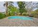 Backyard pool surrounded by brick pavers and mature landscaping at 2812 Ormandy Ct, Tampa, FL 33618