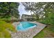 Backyard pool with a brick paver patio and view of the two-story home at 2812 Ormandy Ct, Tampa, FL 33618