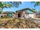 Charming single-story home featuring brick accents, a two-car garage, and an American flag at 3051 Egret Ter, Safety Harbor, FL 34695