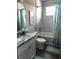 Bathroom featuring a single sink vanity, tiled shower with tub, and coastal-themed decor at 3190 Darius Ave, North Port, FL 34288