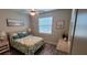 Cozy bedroom with hardwood floors, ceiling fan, and charming coastal themed decor at 3190 Darius Ave, North Port, FL 34288