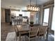 Dining area adjacent to the kitchen featuring a rustic wooden table and modern light fixture at 3190 Darius Ave, North Port, FL 34288