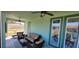 Inviting screened-in lanai with comfortable seating, ceiling fans, and a tranquil view at 3190 Darius Ave, North Port, FL 34288