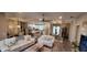 Spacious open-concept living area with stylish furniture, tile floors, and plenty of natural light at 3190 Darius Ave, North Port, FL 34288