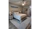 Comfortable main bedroom with a king-size bed, decorative rug, and coastal accents at 3190 Darius Ave, North Port, FL 34288