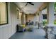 Cozy covered porch featuring stone pillars, ceiling fans, and comfortable seating, perfect for relaxing outdoors at 35150 Roth Ln, Dade City, FL 33525