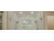 Modern bathroom features a frameless glass shower with double shower heads at 35150 Roth Ln, Dade City, FL 33525
